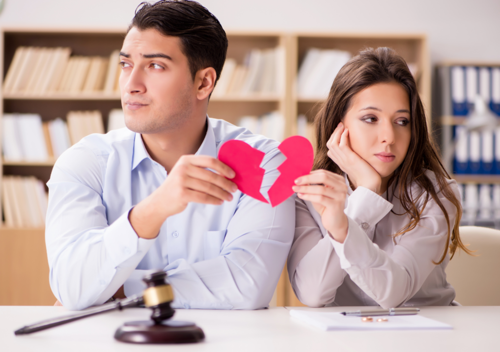Man and woman standing side by side with a broken heart between them, representing relationship breakdown and property division